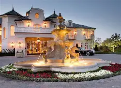 Luxury courtyard entrance for front home design on 1800 yard property with fountain and gated access